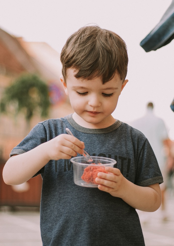 a little boy eating a frozen treat