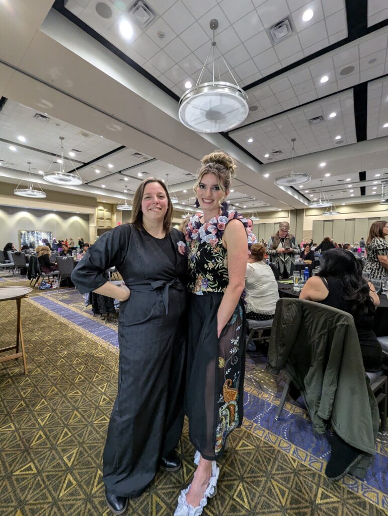 Cirstie shows off her design with her model at the Dress for Success event, Recycle the Runway.