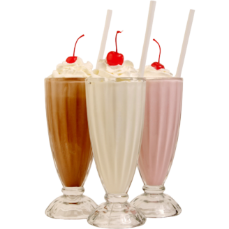 Chocolate, vanilla, and strawberry milkshakes with whip cream and cherries on top