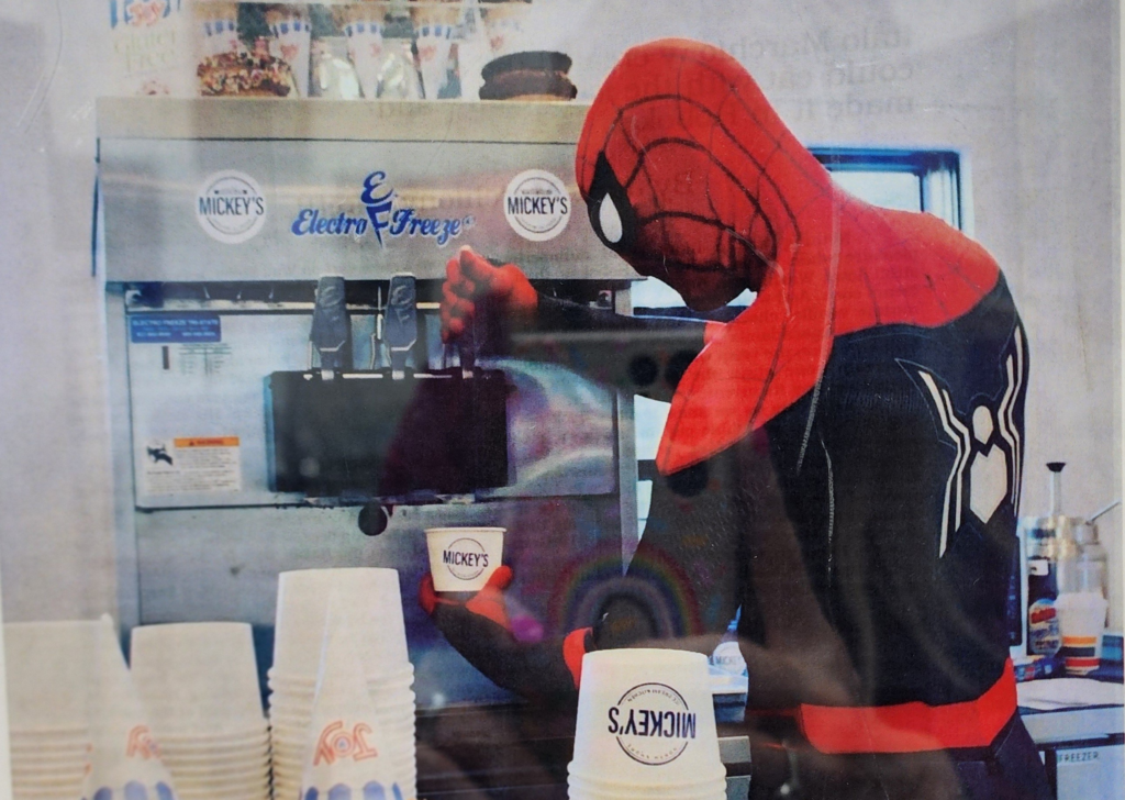Spiderman serving soft serve ice cream from an Electro Freeze machine