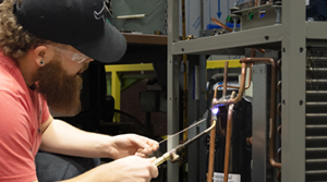 An Electro Freeze employee works on a frozen treat machine