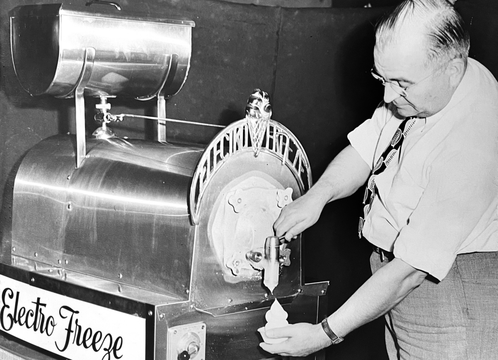 Founder of Electro Freeze, Charles Ericson, serves soft serve from one of the original soft serve machines